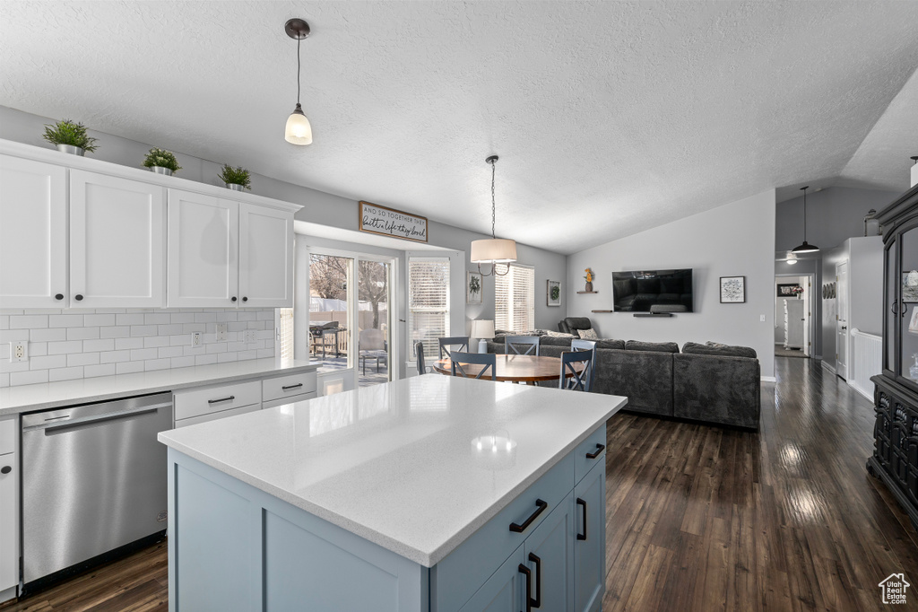 Kitchen with dishwasher, dark wood-type flooring, open floor plan, and white cabinets