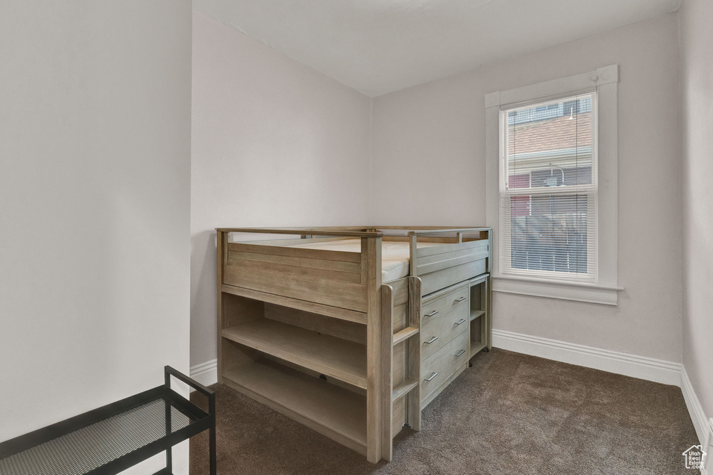 Carpeted bedroom with baseboards
