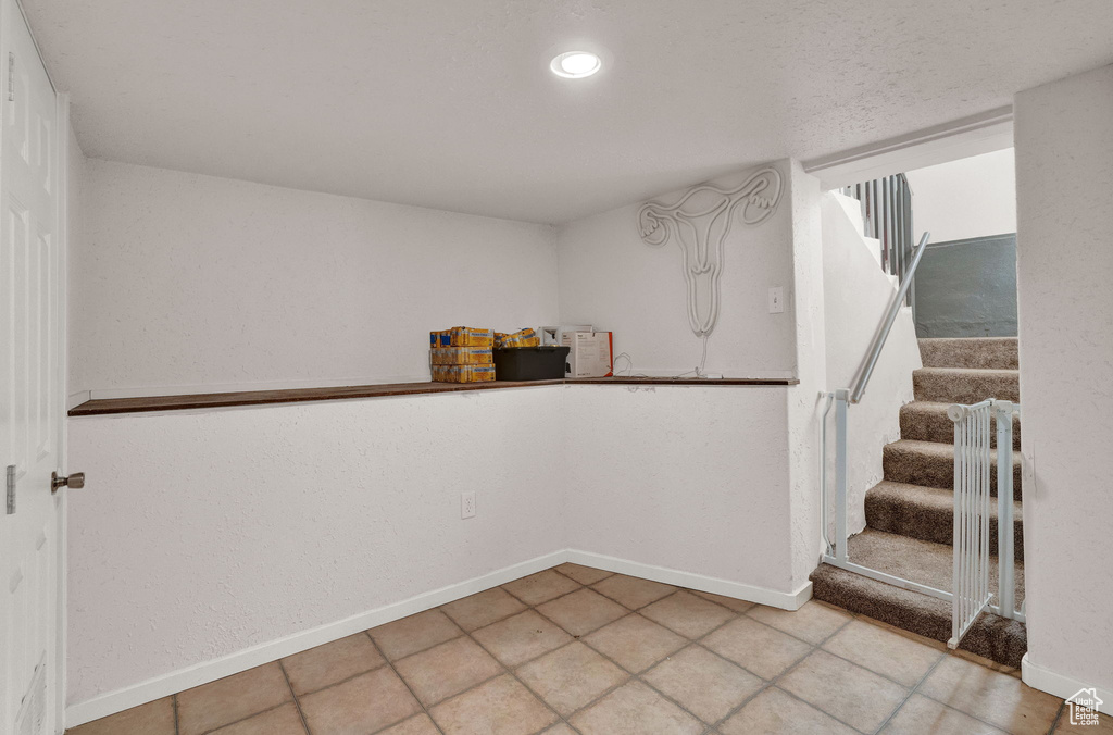 Interior space with recessed lighting, stairway, and baseboards