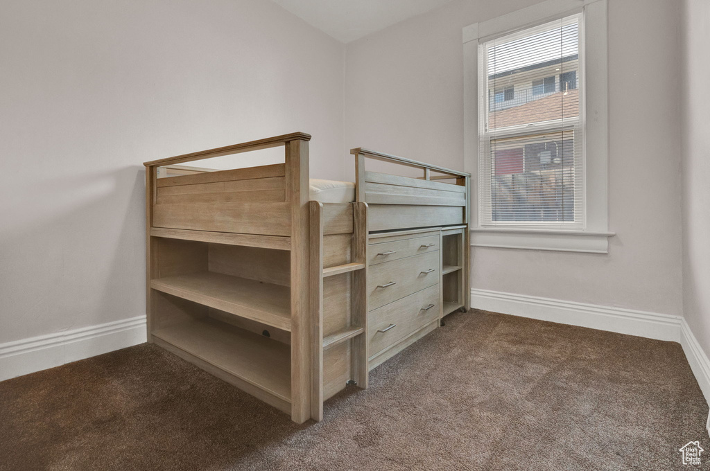 Unfurnished bedroom with carpet floors and baseboards