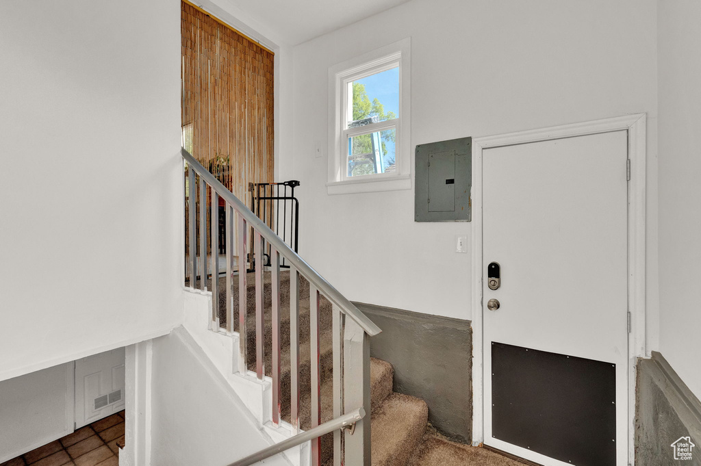Staircase with electric panel and visible vents