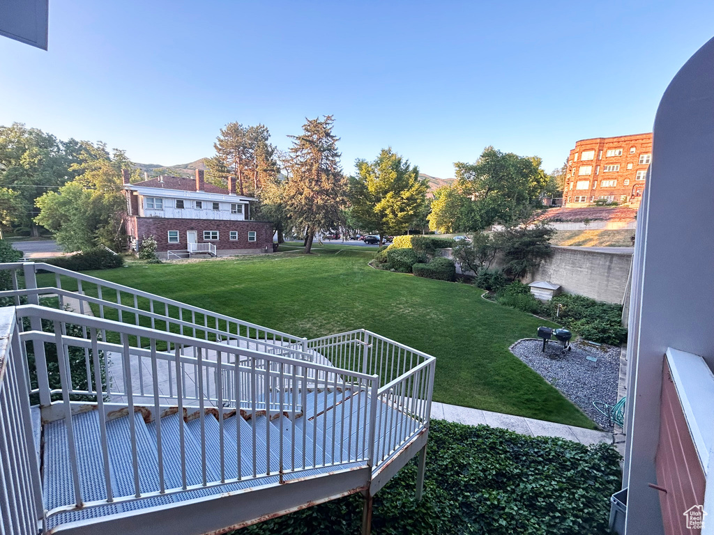 View of grassy yard with a deck