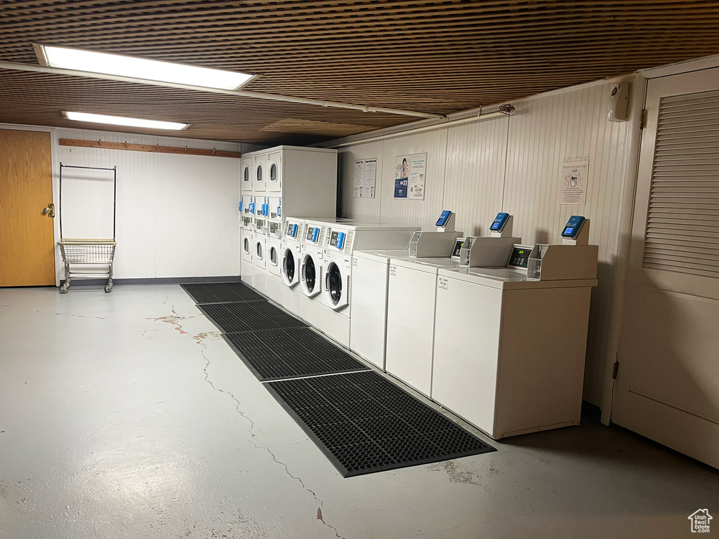 Misc room with concrete flooring, washing machine and clothes dryer, and stacked washer and clothes dryer
