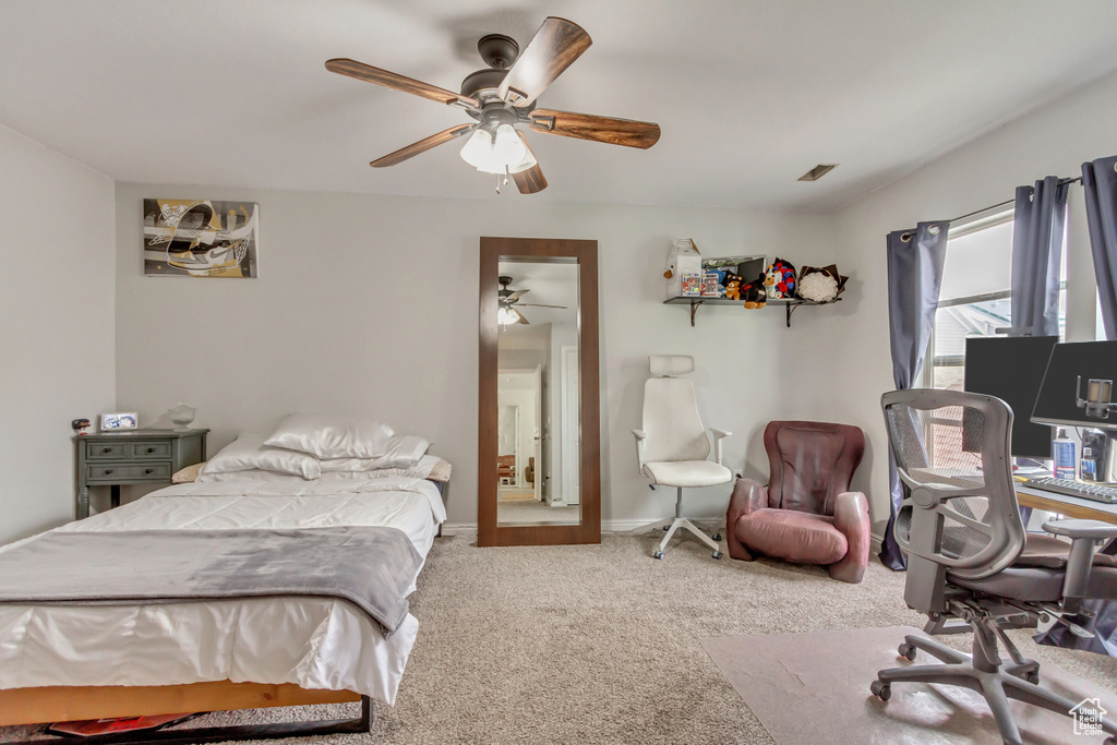 Bedroom featuring a ceiling fan, baseboards, visible vents, and carpet flooring