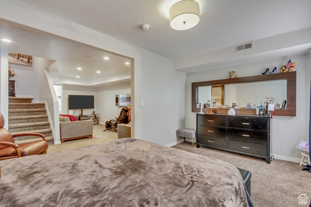 Bedroom featuring light carpet, baseboards, visible vents, and recessed lighting