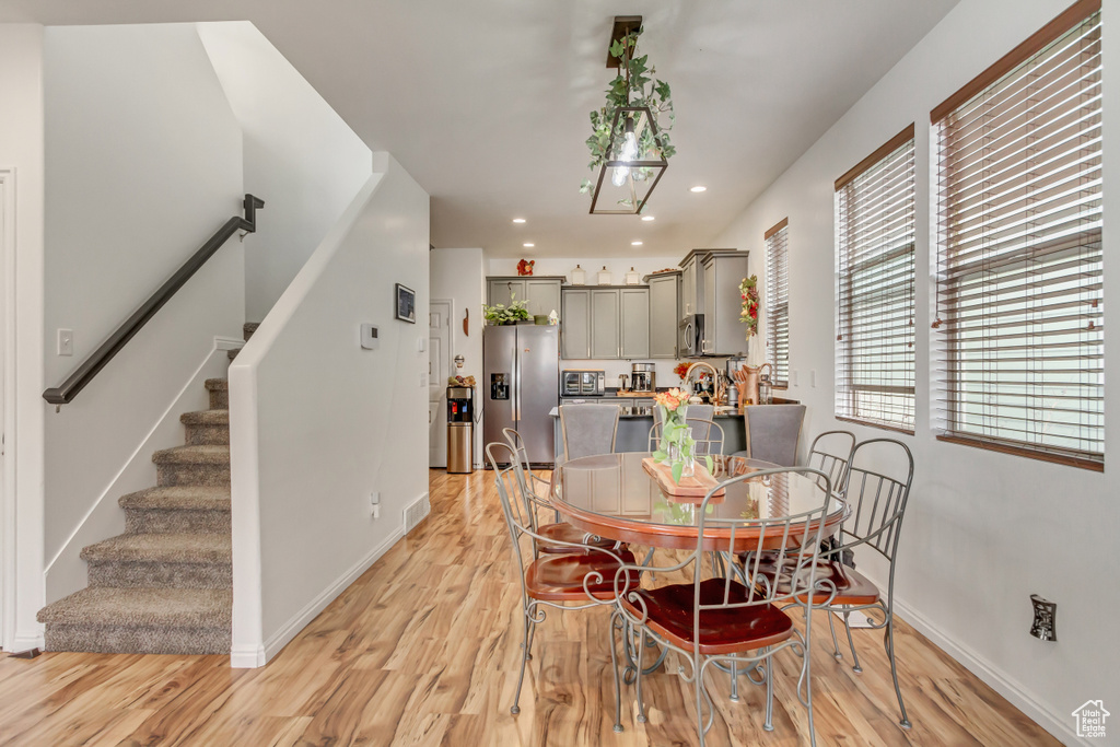 Dining space with stairs, recessed lighting, baseboards, and light wood-style floors