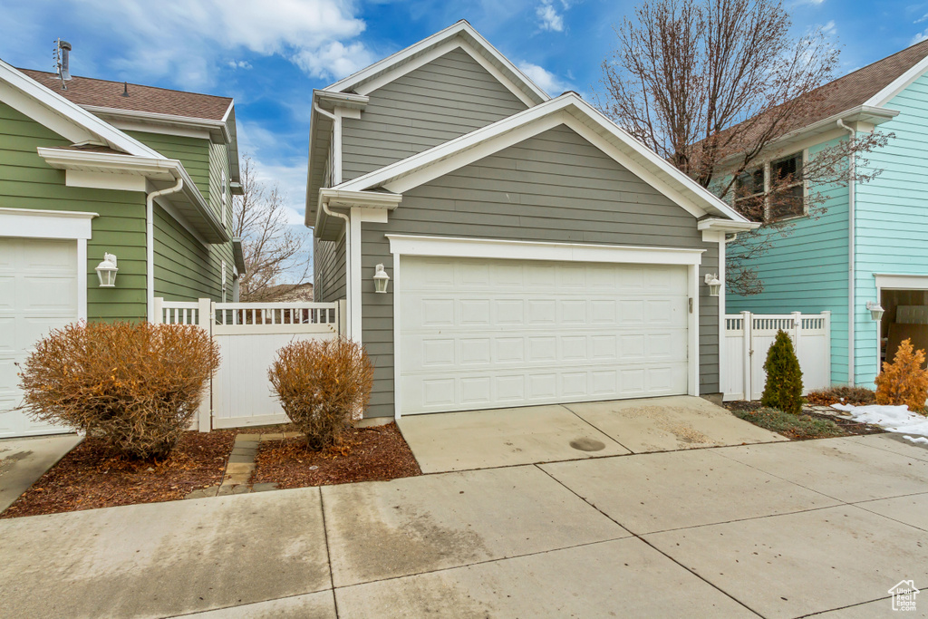 View of front of home with fence and driveway