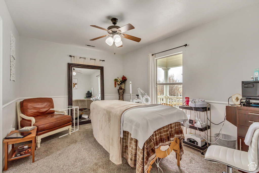 Bedroom featuring visible vents, carpet flooring, and a ceiling fan
