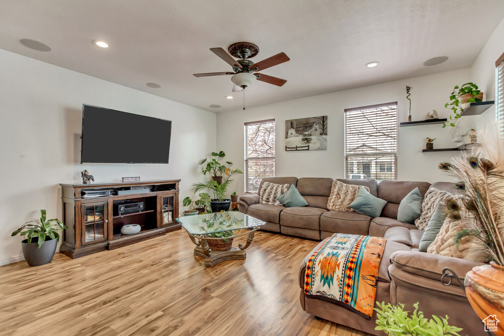Living area with a ceiling fan, recessed lighting, and wood finished floors