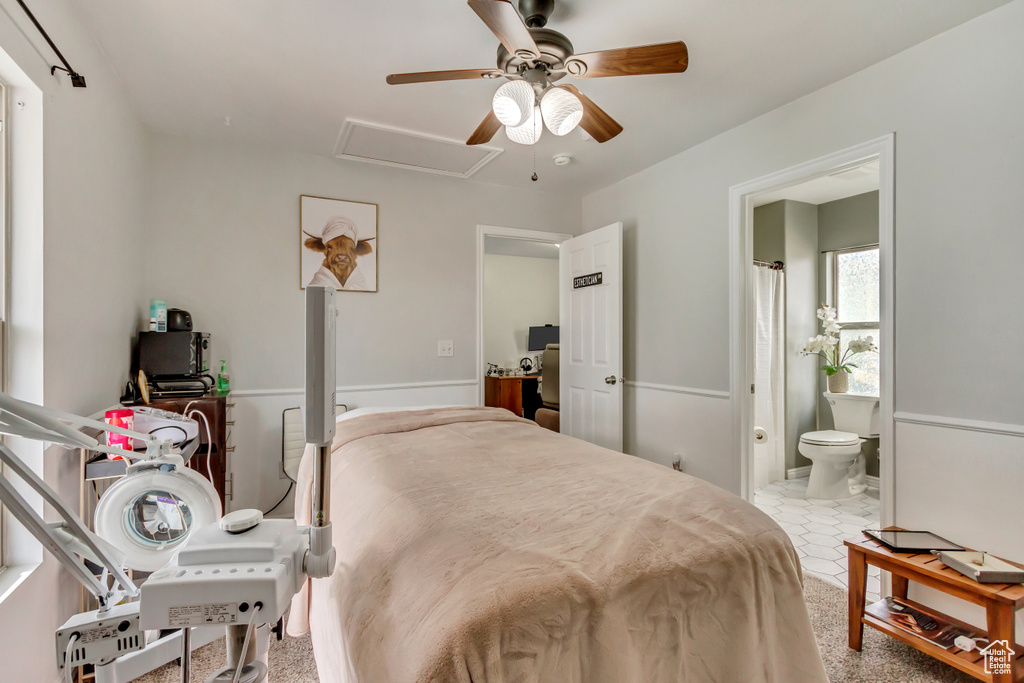 Bedroom with attic access, ceiling fan, and ensuite bathroom