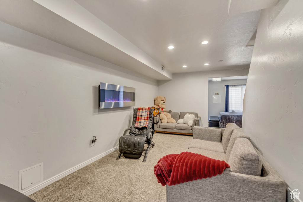 Living area with carpet floors, visible vents, baseboards, and recessed lighting