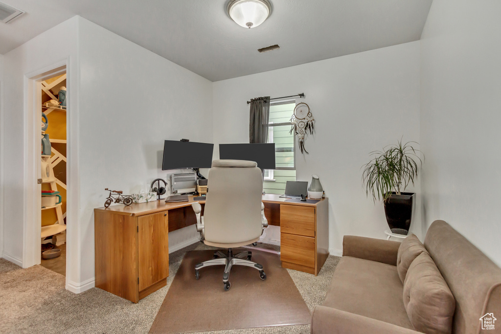 Office with carpet flooring, visible vents, and baseboards
