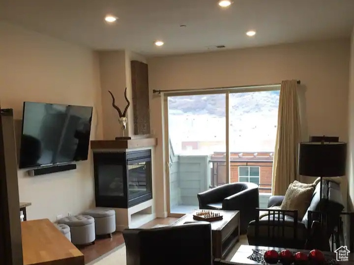 Living room with dark wood-type flooring and recessed lighting