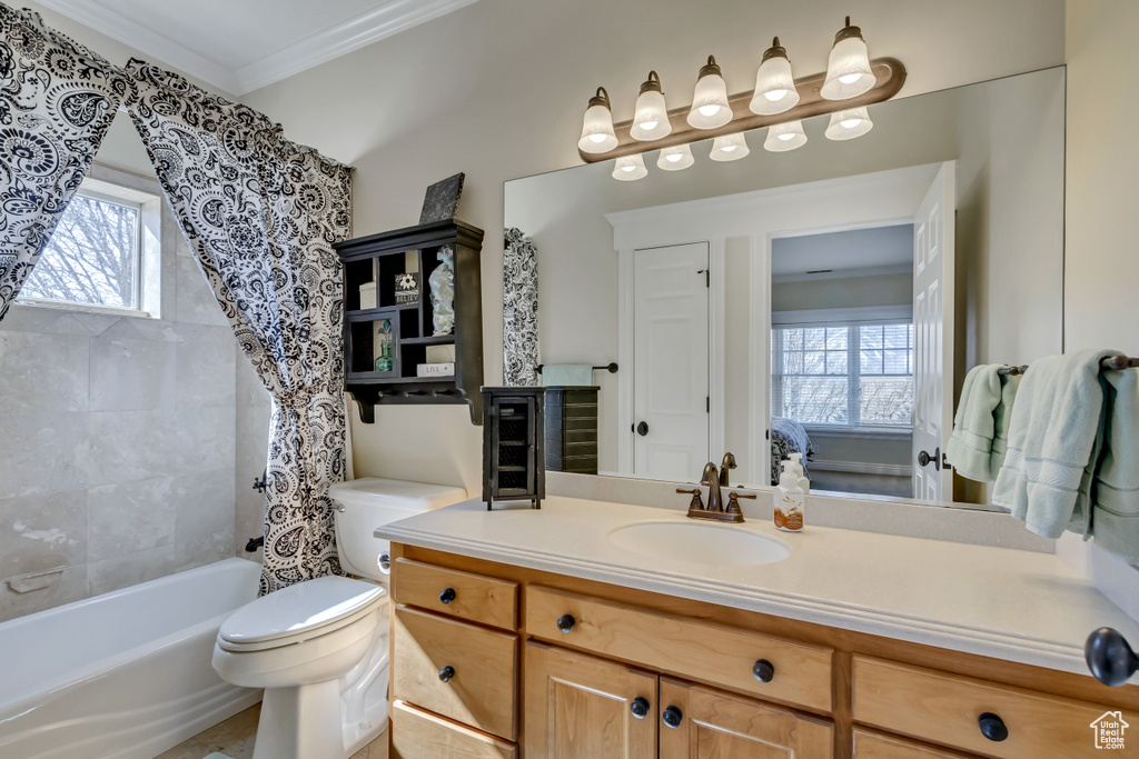 Full bathroom with a wealth of natural light, crown molding, vanity, and toilet