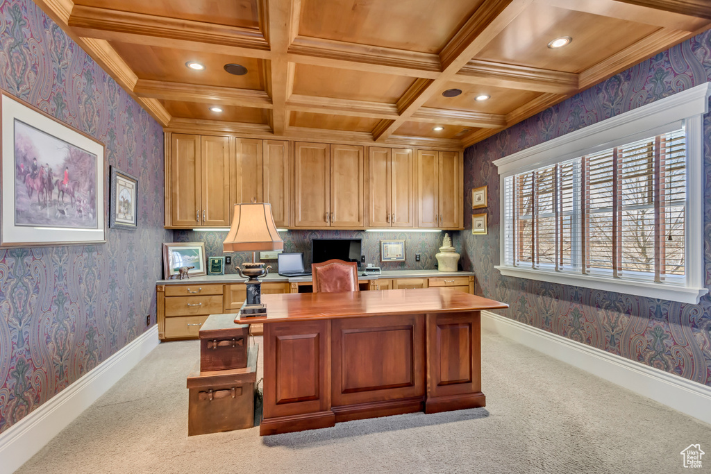 Home office featuring coffered ceiling, light carpet, and wallpapered walls