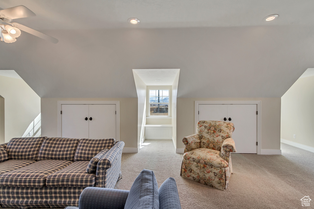 Living area featuring recessed lighting, light colored carpet, a ceiling fan, vaulted ceiling, and baseboards