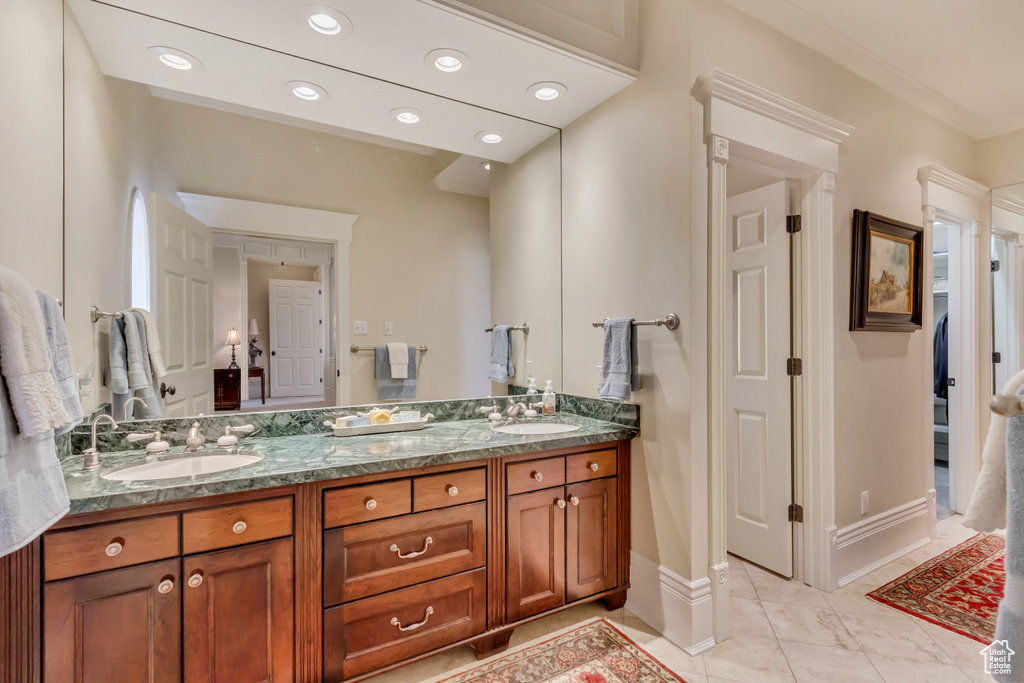 Full bath featuring recessed lighting, a sink, baseboards, and double vanity