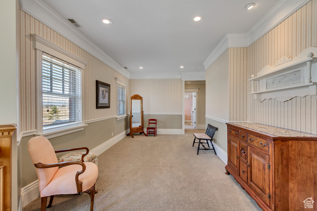 Living area featuring recessed lighting, light carpet, crown molding, and baseboards