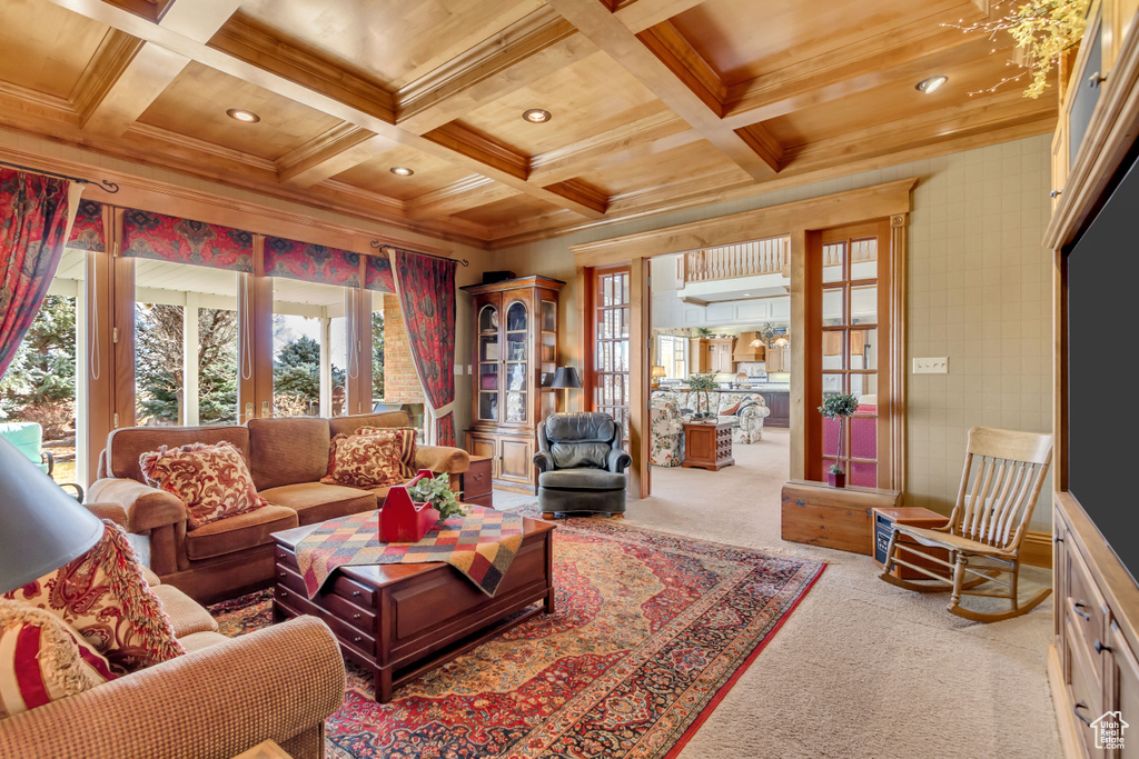 Carpeted living area featuring ornamental molding, recessed lighting, coffered ceiling, and beamed ceiling