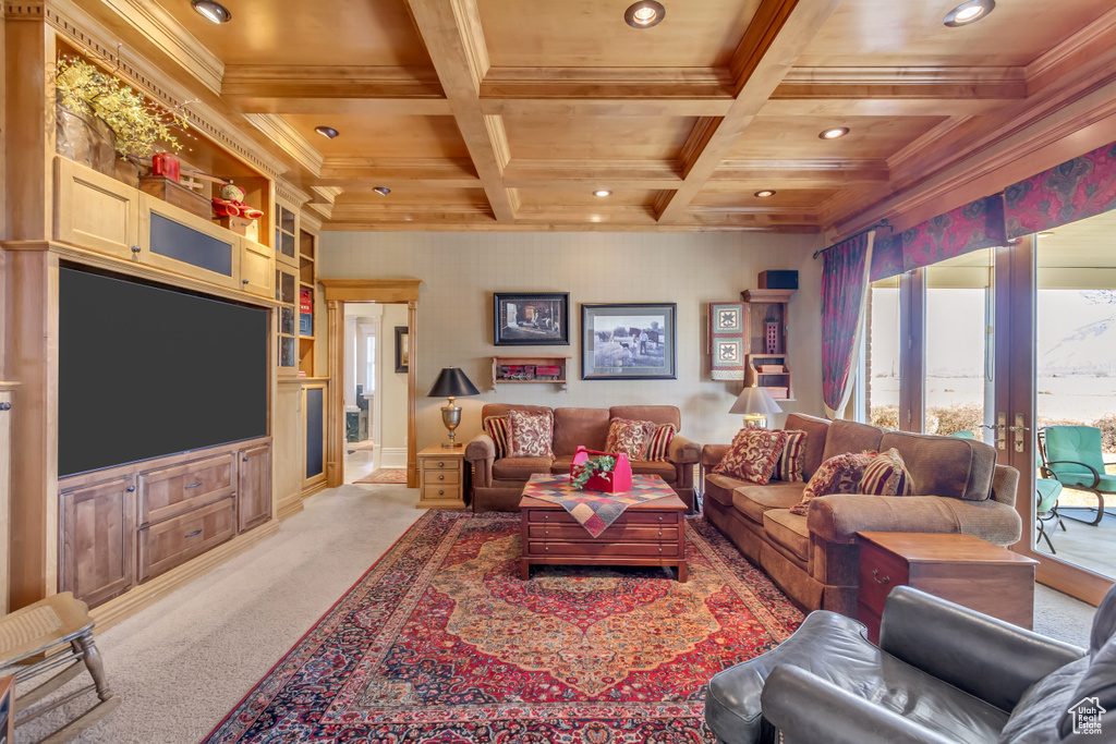 Living area with coffered ceiling, light colored carpet, crown molding, french doors, and beam ceiling