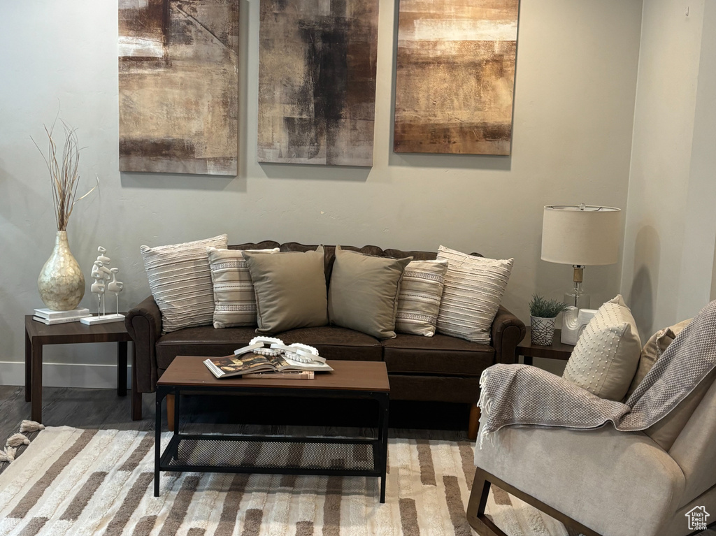 Living room with wood finished floors, baseboards, and recessed lighting