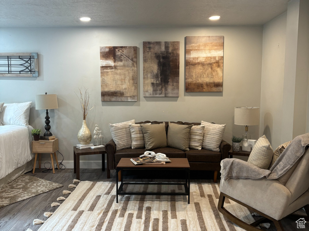 Living area featuring wood finished floors, recessed lighting, and baseboards
