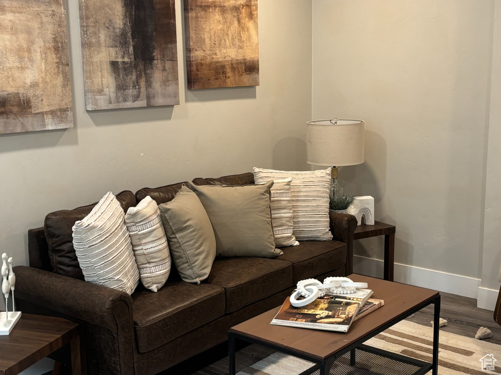 Living area with wood finished floors, baseboards, and recessed lighting