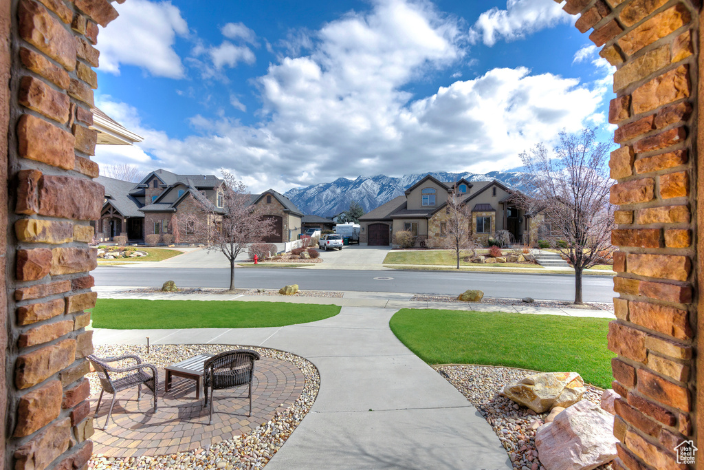 Exterior space featuring an outdoor fire pit, a residential view, and a mountain view