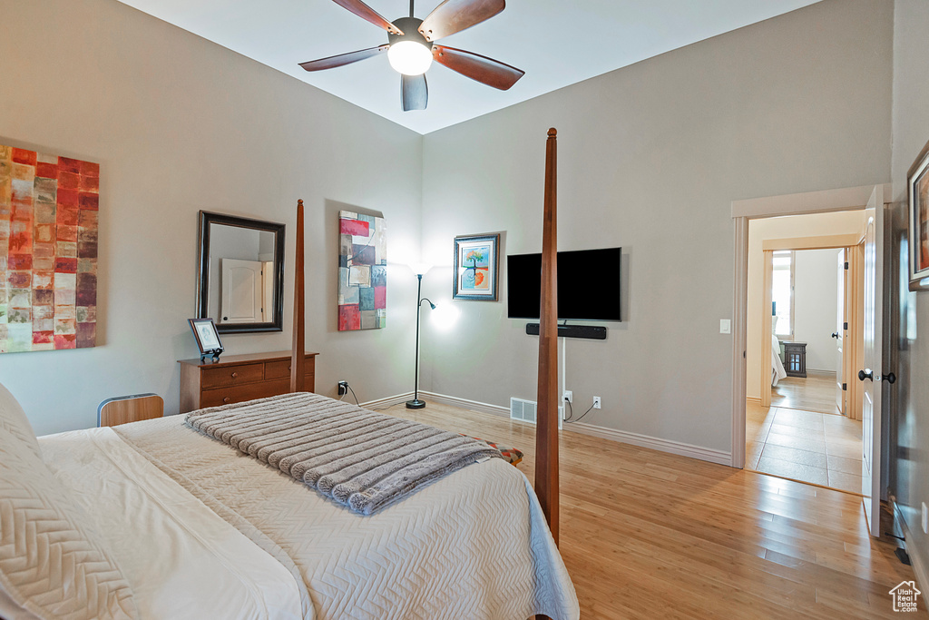 Bedroom with baseboards, a ceiling fan, and light wood-style floors