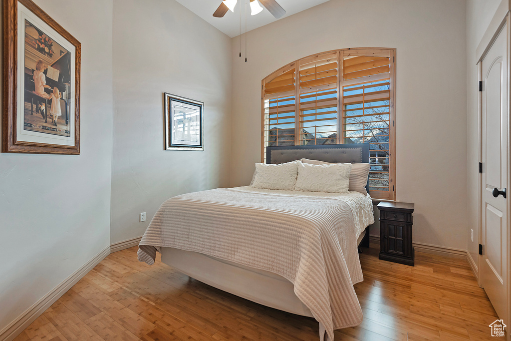 Bedroom with baseboards, ceiling fan, and light wood finished floors