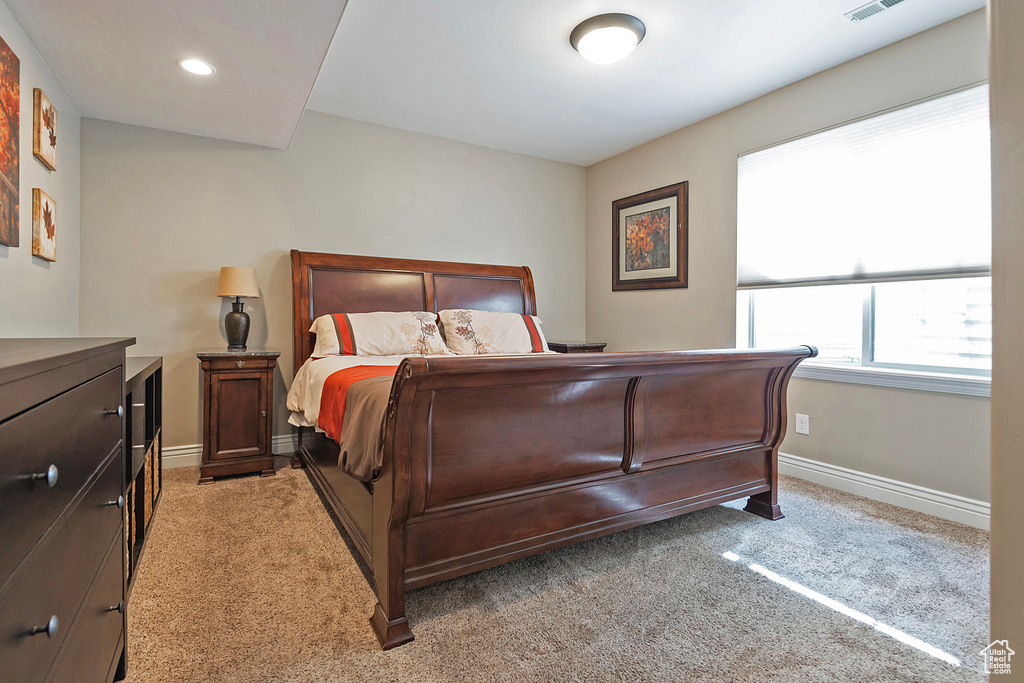 Bedroom featuring light carpet, recessed lighting, visible vents, and baseboards