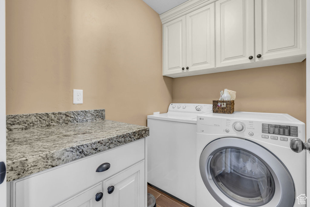 Clothes washing area with washing machine and dryer and cabinet space