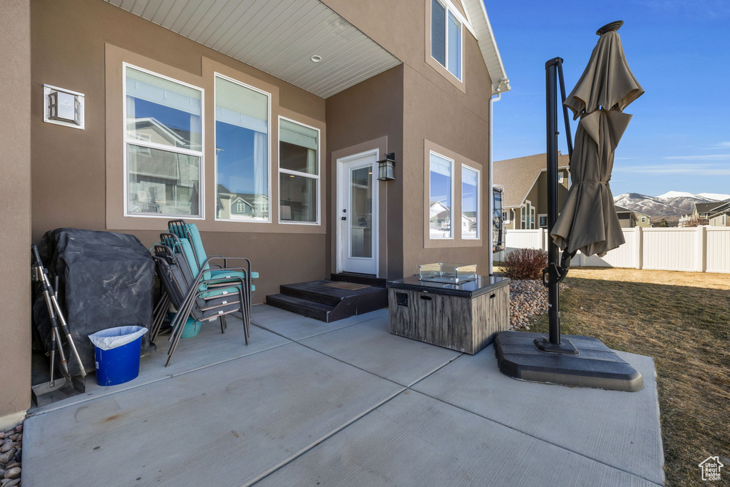 View of patio with fence and a mountain view