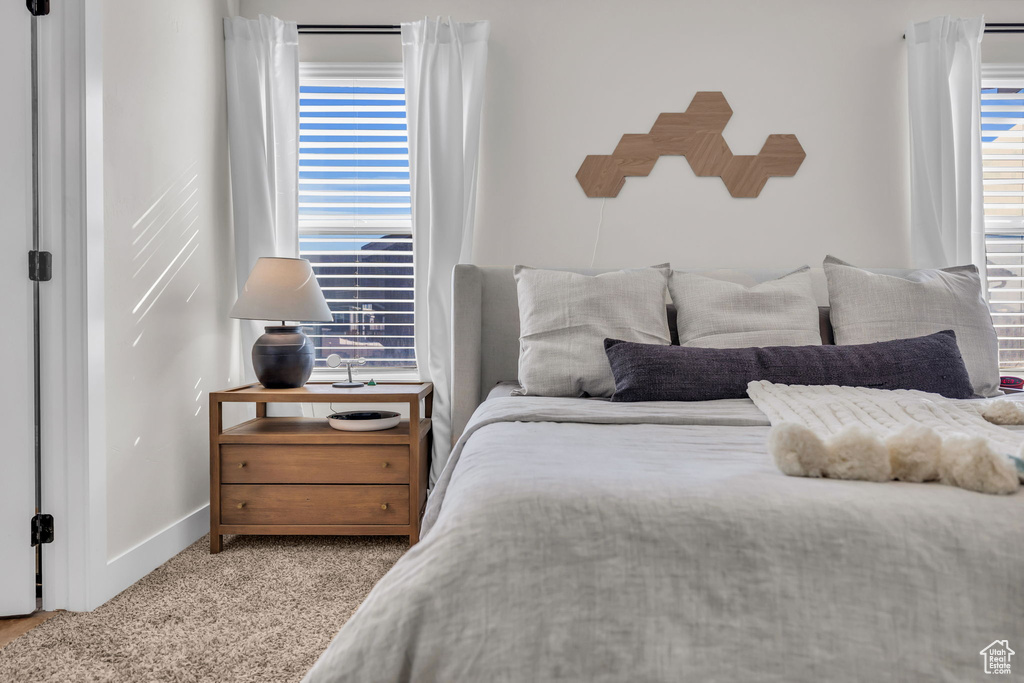 Bedroom with carpet flooring and baseboards