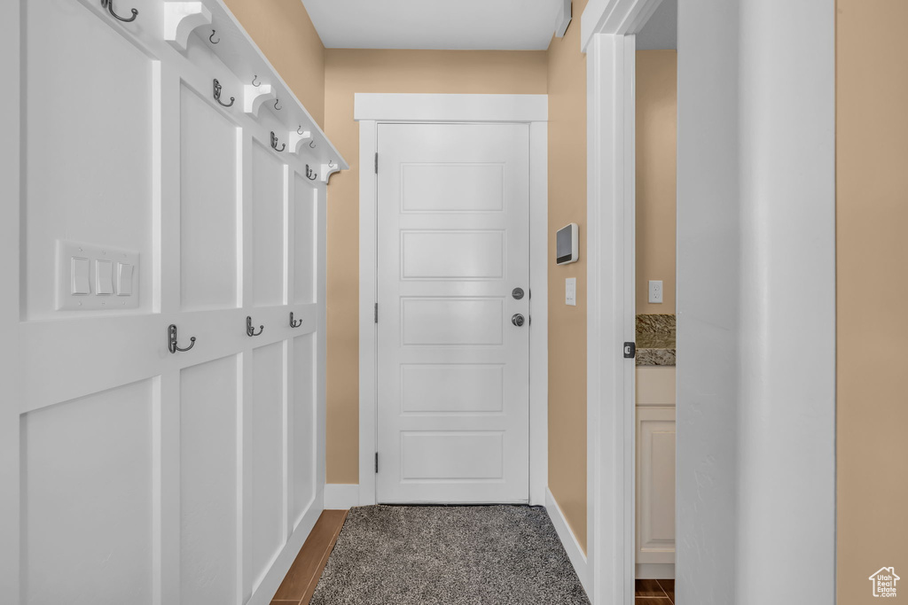 Entryway featuring baseboards and dark wood-type flooring