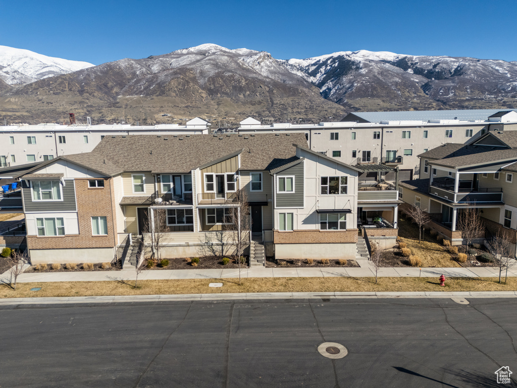 View of front of property with a residential view and a mountain view