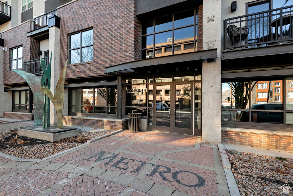 Entrance to property featuring french doors and brick siding