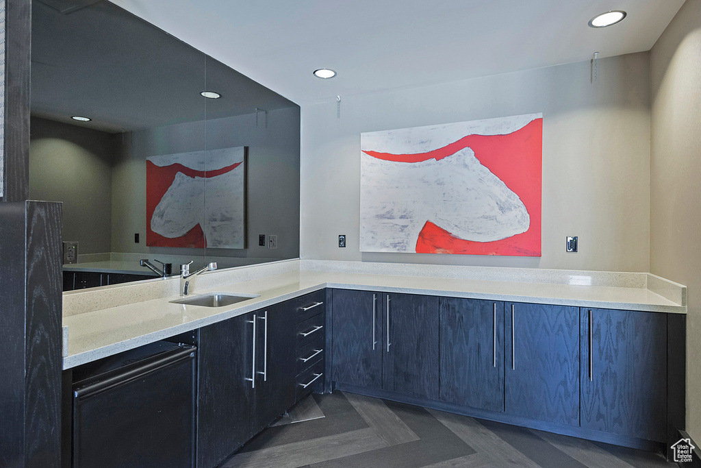 Interior space with light countertops, a sink, and recessed lighting