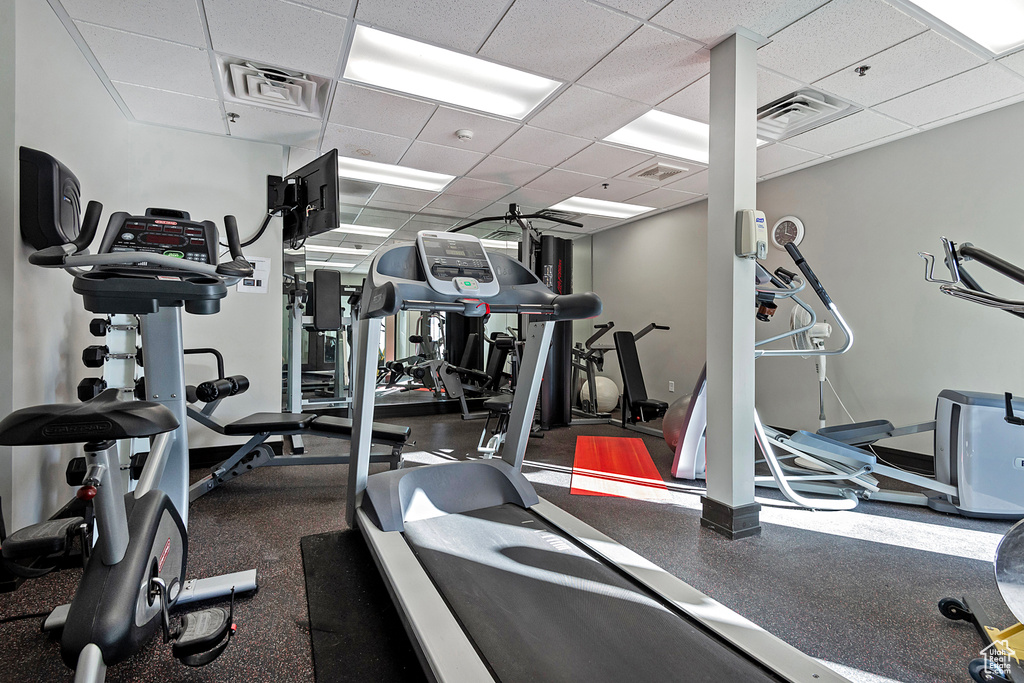 Workout area featuring a drop ceiling and visible vents