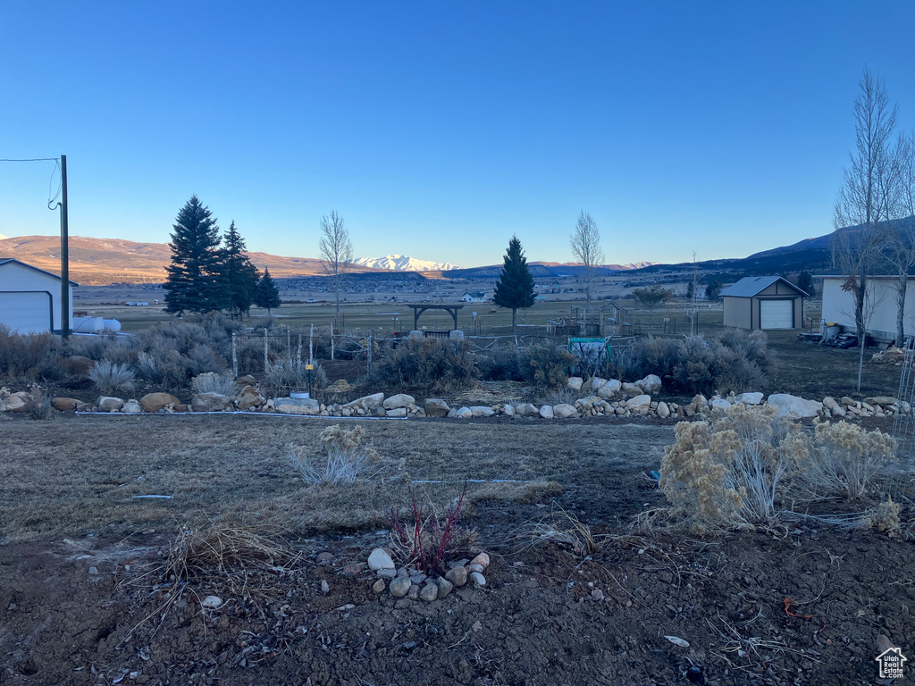 View of yard featuring a mountain view and an outdoor structure