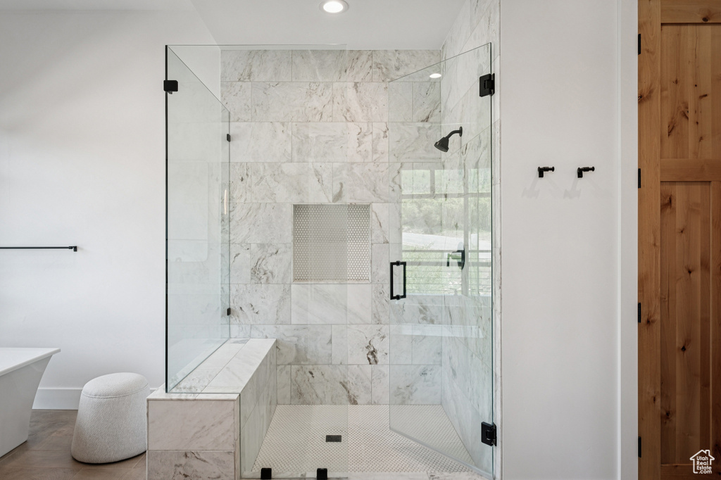 Full bath featuring a shower stall, recessed lighting, and a freestanding tub