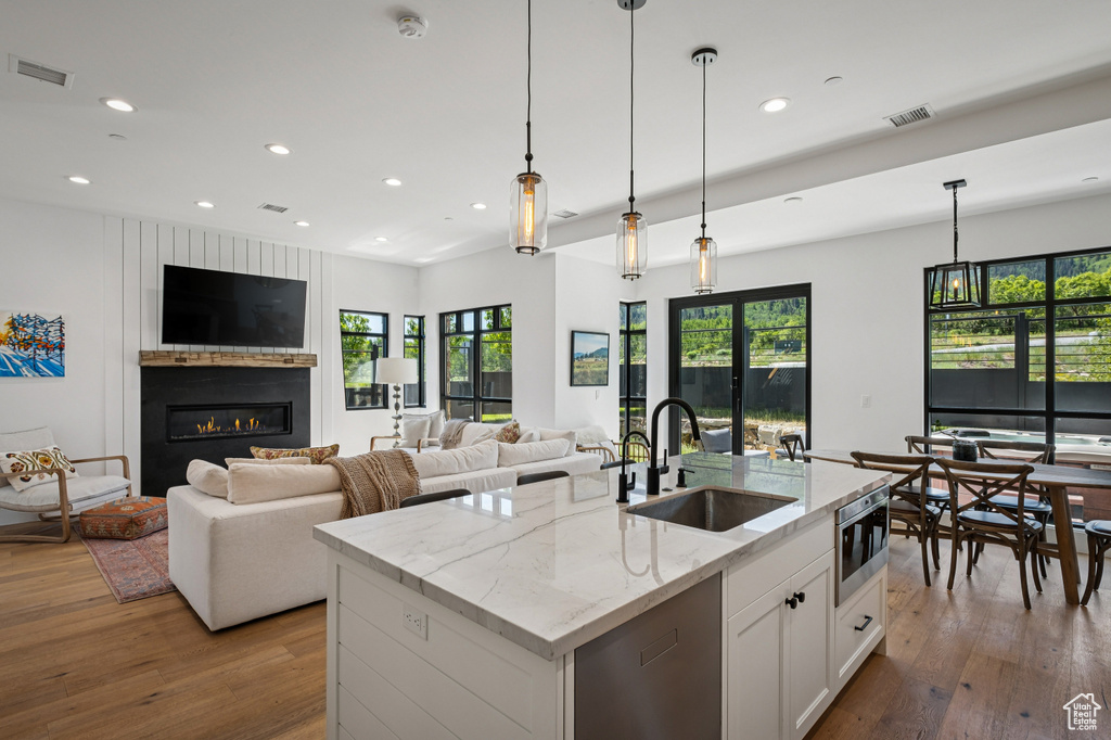 Kitchen featuring hardwood / wood-style flooring, recessed lighting, and plenty of natural light