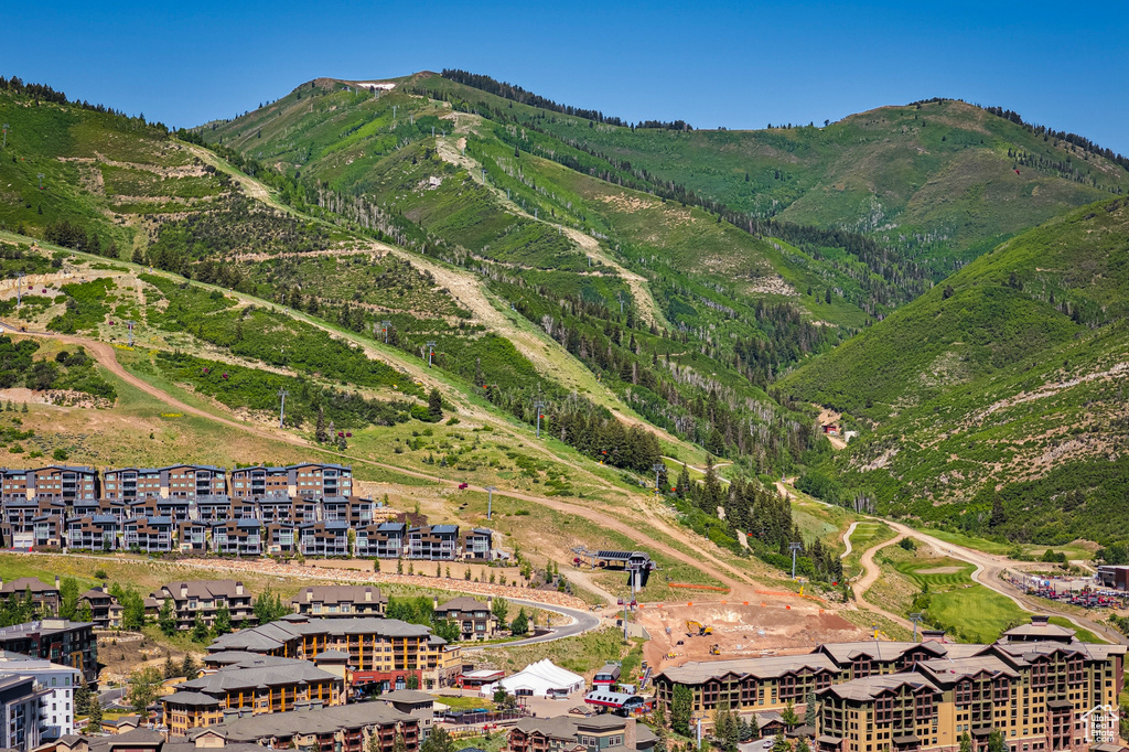 Aerial view of property and surrounding area with mountains
