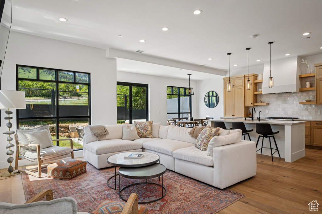 Living room featuring recessed lighting and light wood-style flooring
