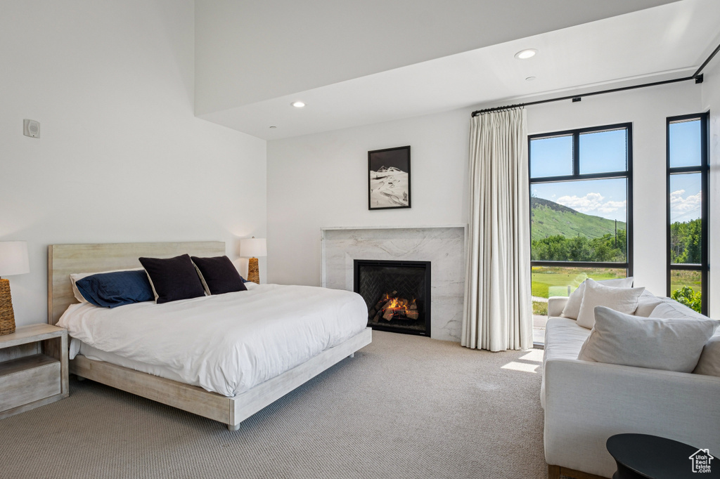 Bedroom with carpet floors, a premium fireplace, and recessed lighting