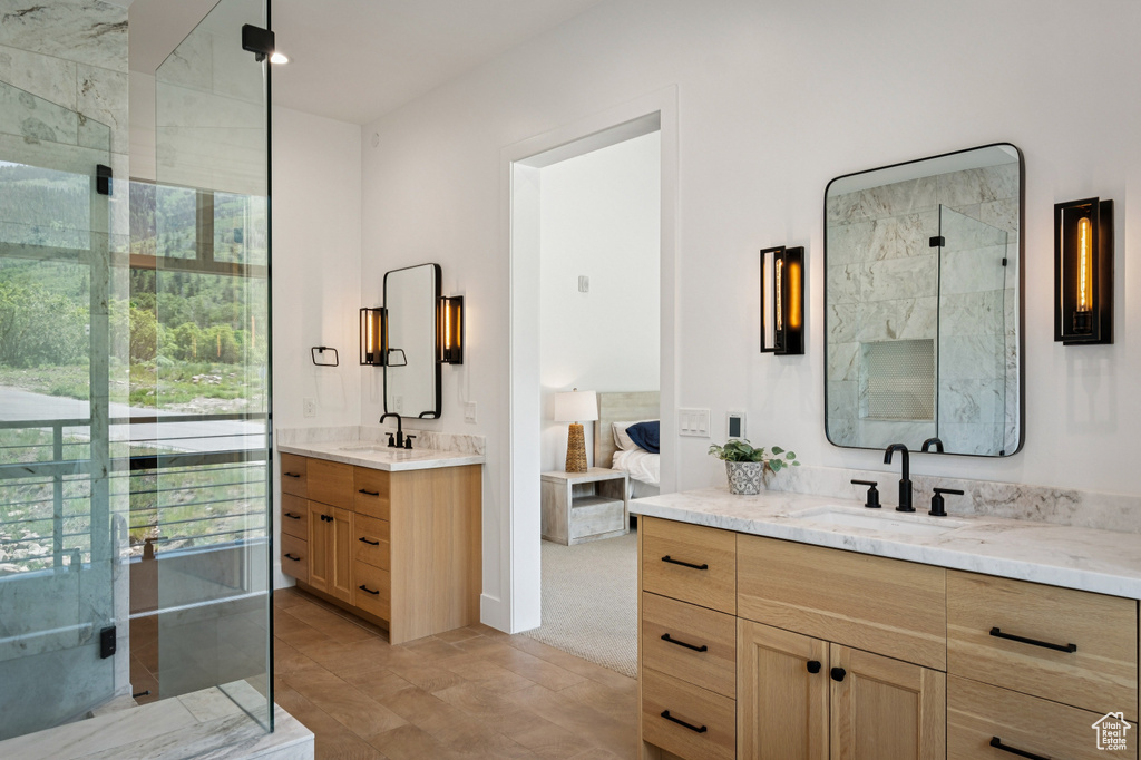 Ensuite bathroom featuring two vanities and a shower stall