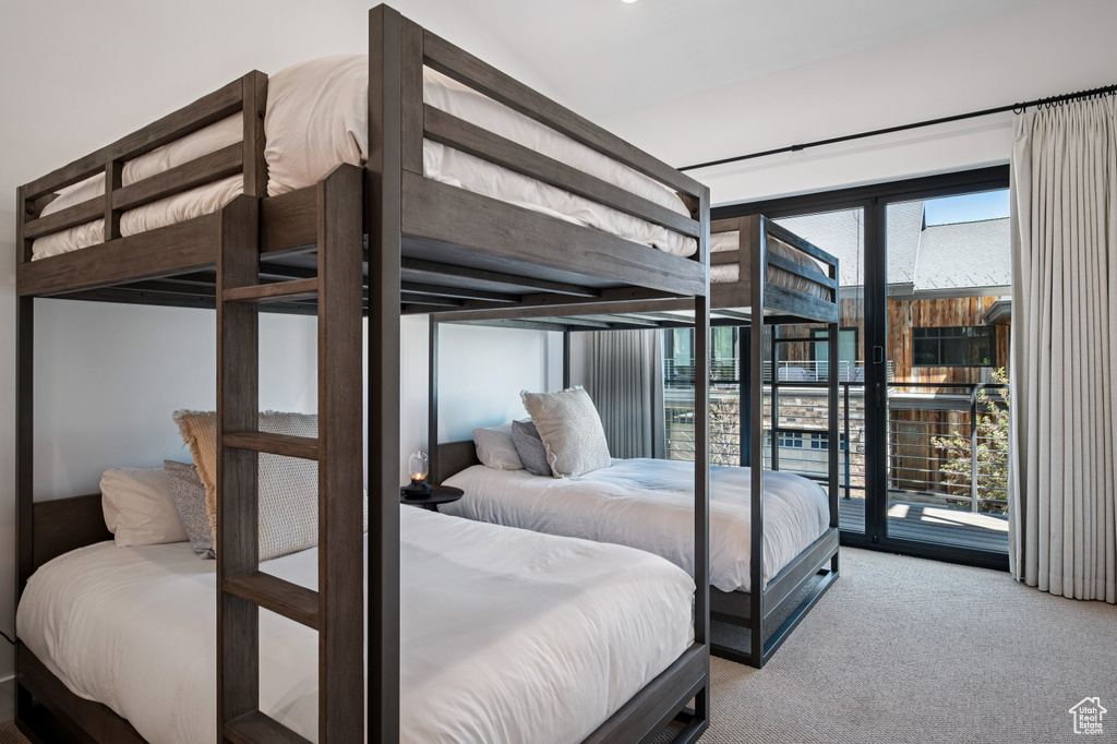 Bedroom with carpet and access to exterior