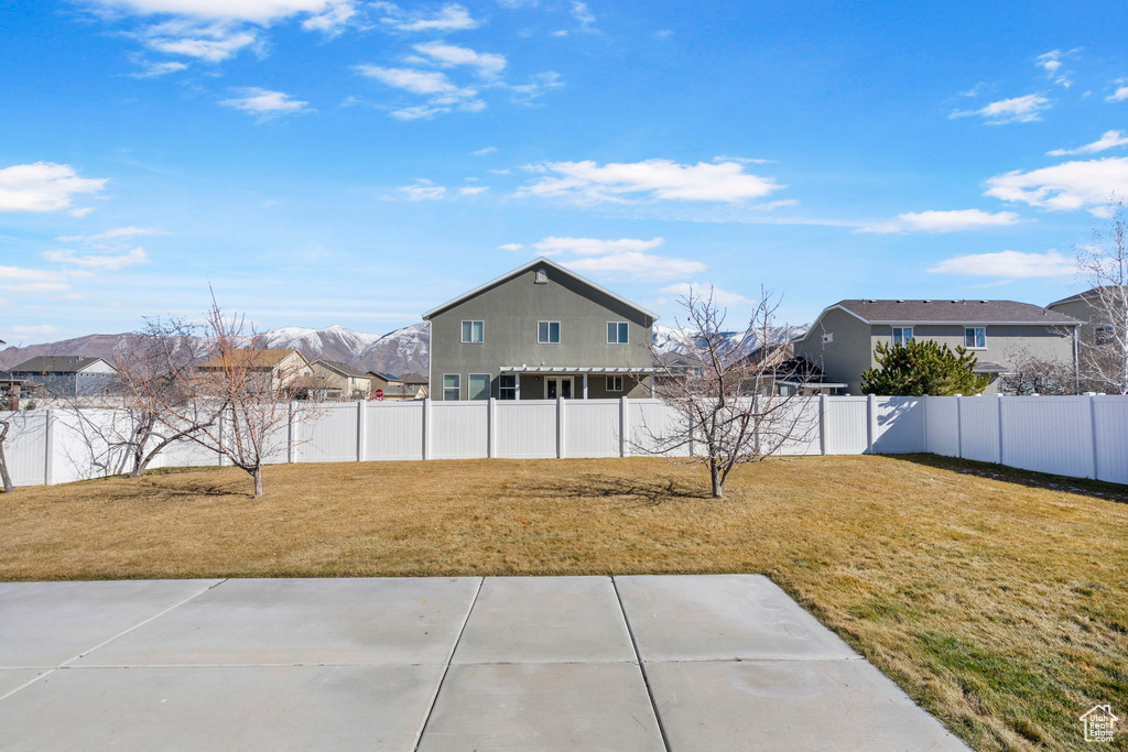 View of yard with a fenced backyard and a patio