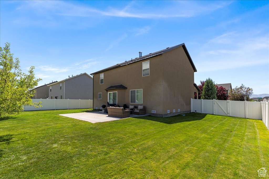 Rear view of property with an outdoor hangout area and a patio area
