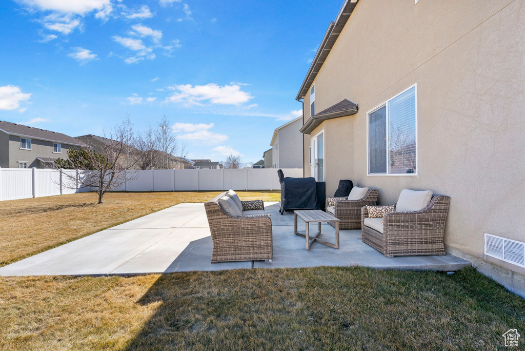 View of patio / terrace with an outdoor living space, a fenced backyard, and visible vents